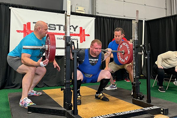 alex at the bottom of a 175 kg squat