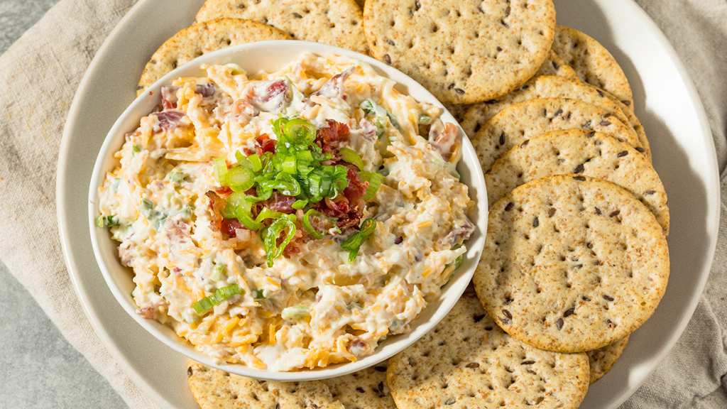 Million dollar dip with a platter full of crackers