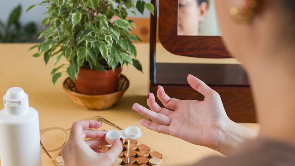 Woman taking contacts out