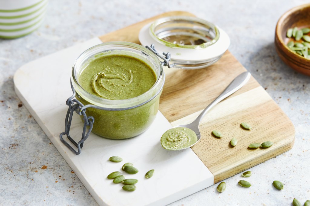 creamy pumpkin seed butter in jar with spoon