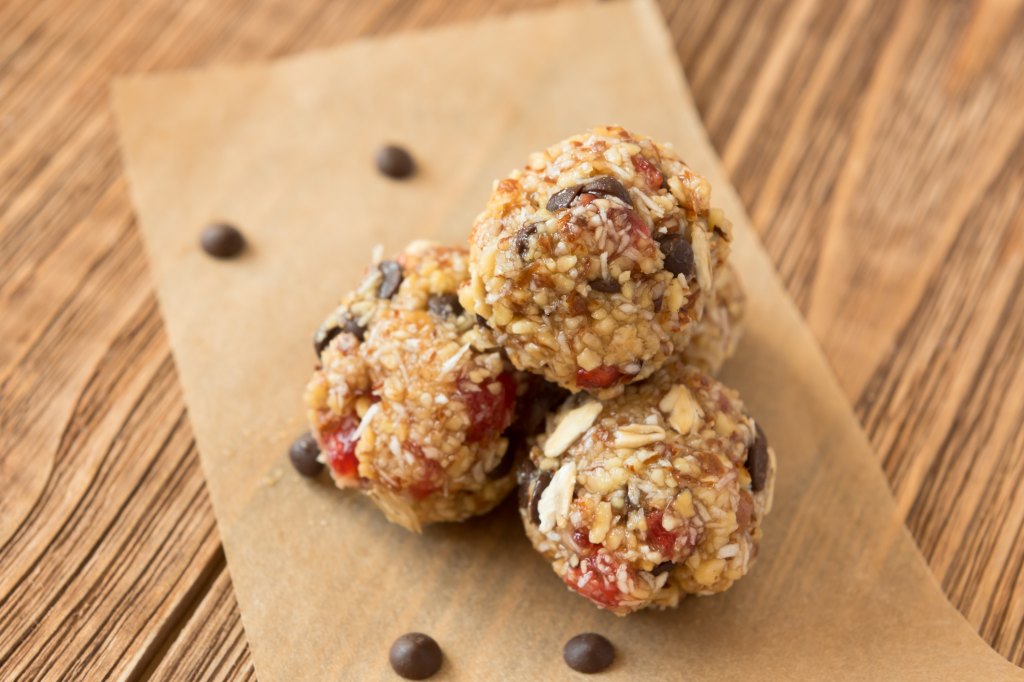 energy bite balls with pumpkin seeds on wooden background 