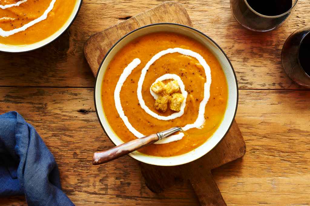 overhead view of butternut squash soup in bowl as part of a roundup of thanksgiving appetizers