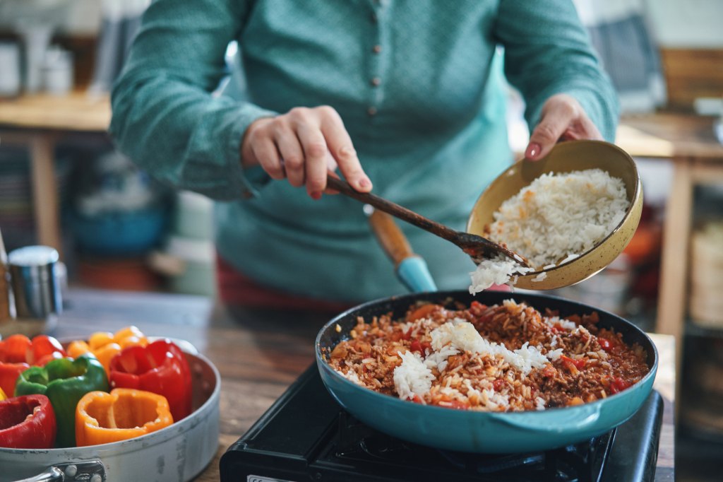 mature woman getting creative in the kitchen and making a meal with pantry staples