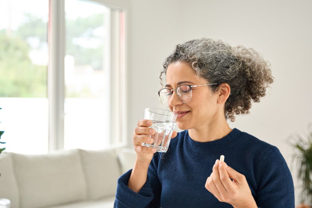 mature woman drinking water to support proper ozempic injection