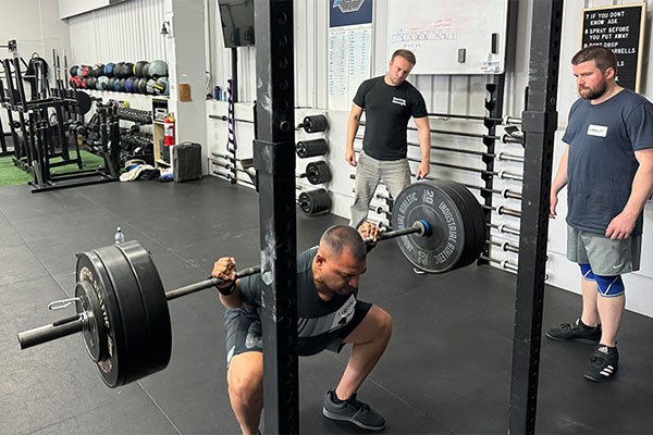 farhan at the bottom of a squat at the training camp