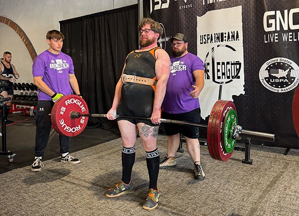 collin locks out a deadlift in powerlifting competition