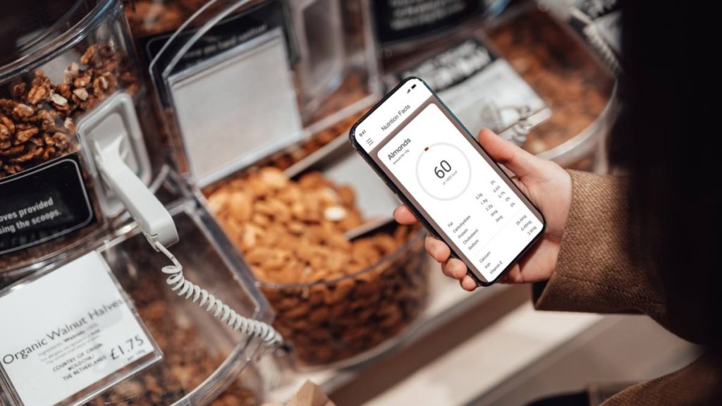 Woman holding phone to count calories
