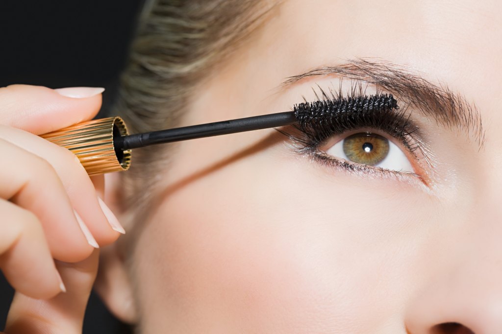 Woman applying mascara