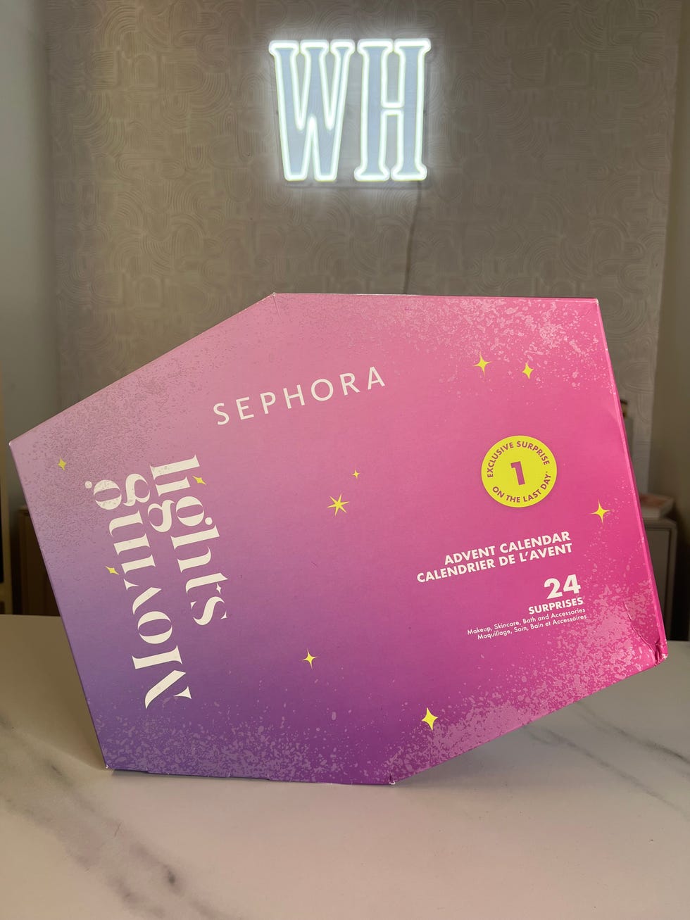 sephora advent calendar with a pink to purple gradient design detailing 24 surprises