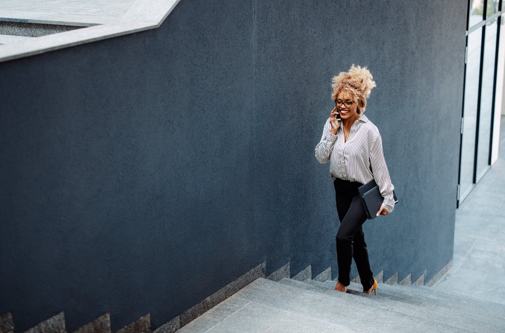 woman walking up steps on the phone