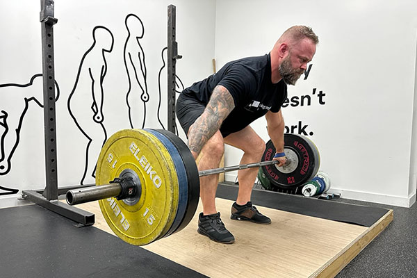 josh wells in the middle of a snatch grip deadlift