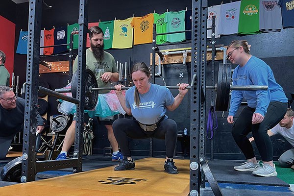 becky at the bottom of a pr 315 squat