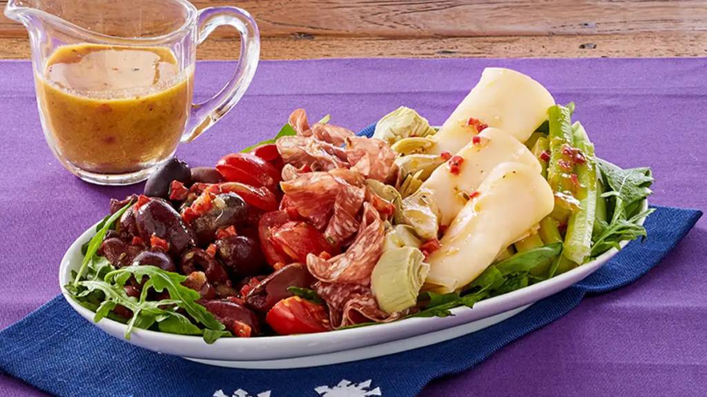 Antipasto with red pepper vinaigrette as part of a recipe roundup of New Year's Eve appetizers