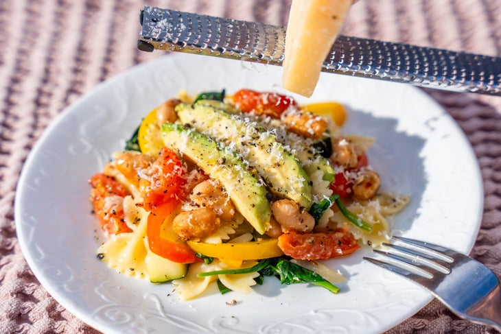 Avocado primavera pasta with beans and Parmesan cheese.