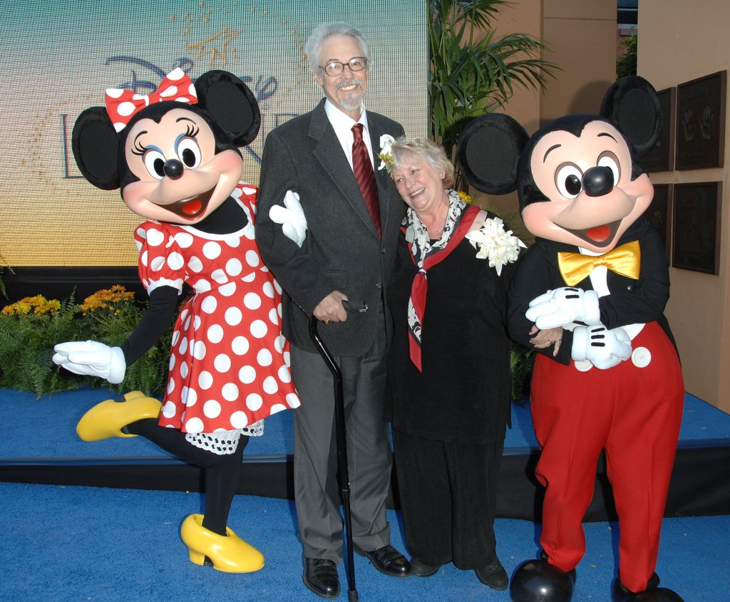 couple posing with mickey and minnie