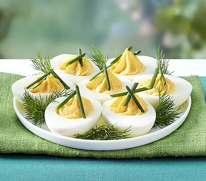 Herbed deviled eggs as part of a recipe roundup of New Year's Eve appetizers