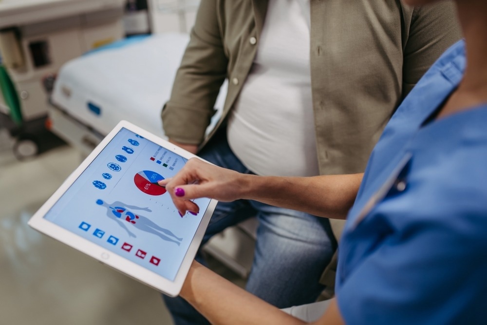 Close up of female doctor consulting with overweight patient