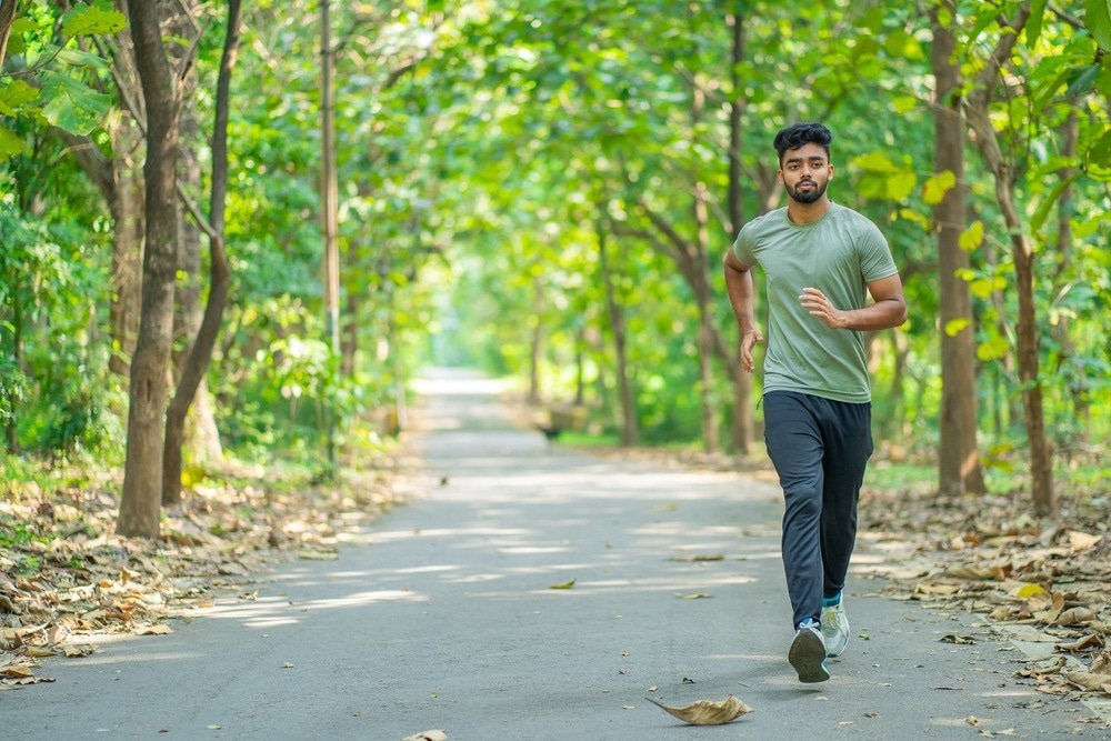 Young man running in the park at morning