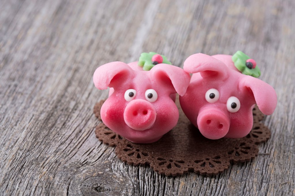 Marzipan pig-shaped treats as part of a roundup of lucky New Year's food traditions