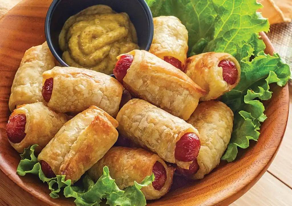 Pigs in a blanket as part of a recipe roundup of New Year's Eve appetizers