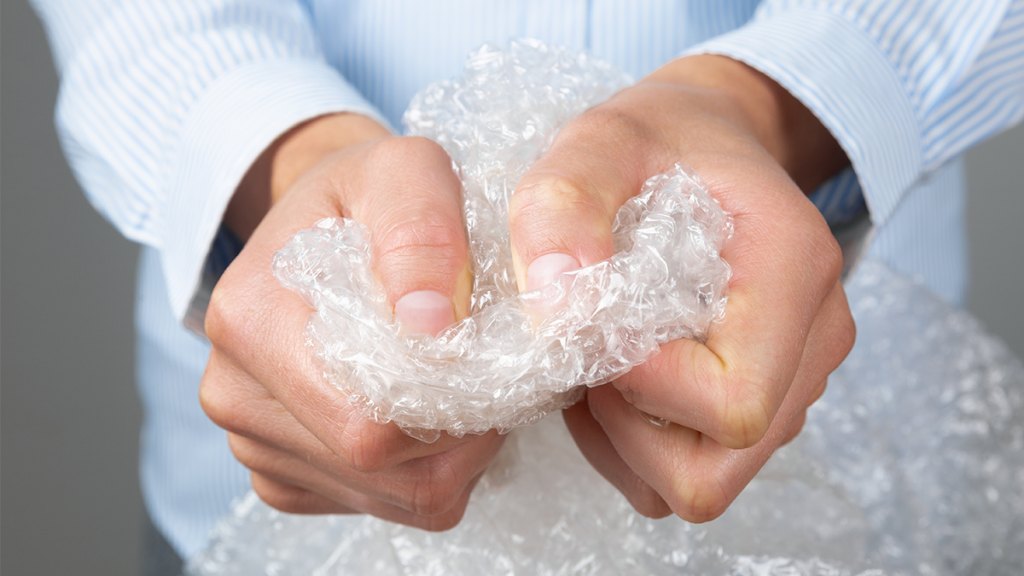 woman popping bubble wrap