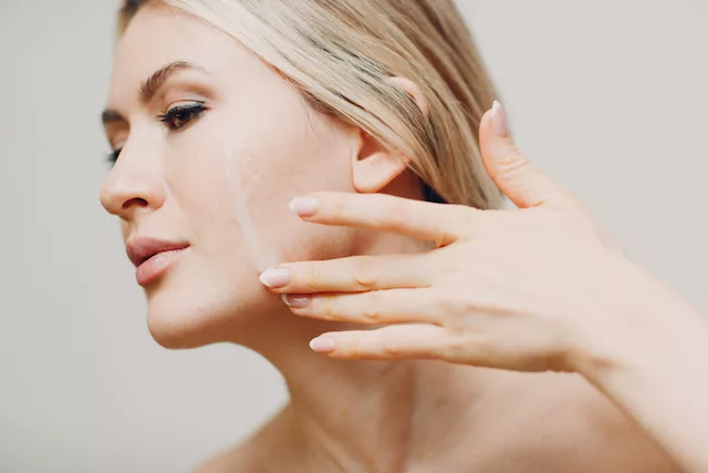 Dry and patchy skin. Woman hydrating her skin.