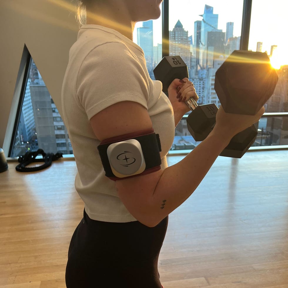 person exercising with dumbbells in a fitness studio