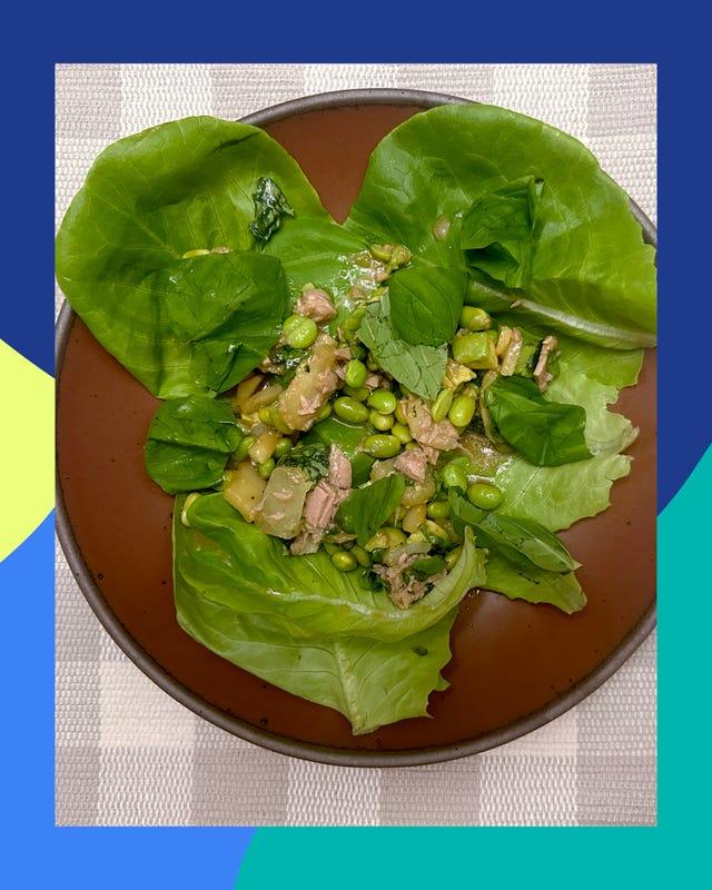 a bowl filled with leafy greens and mixed ingredients