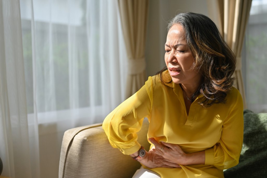 mature woman experiencing gastrointestinal side effects from zepbound and wegovy medications