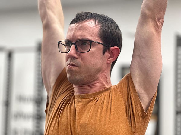 close up of a lifter shrugging during a press