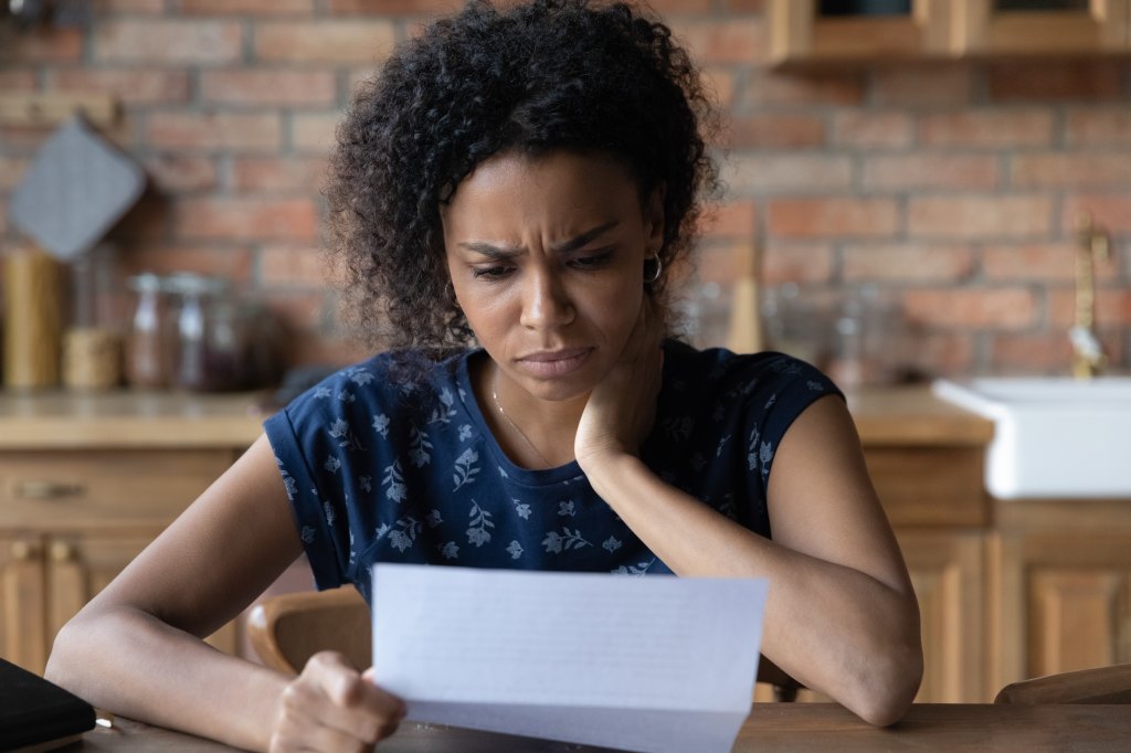 woman looking at letter, concerned