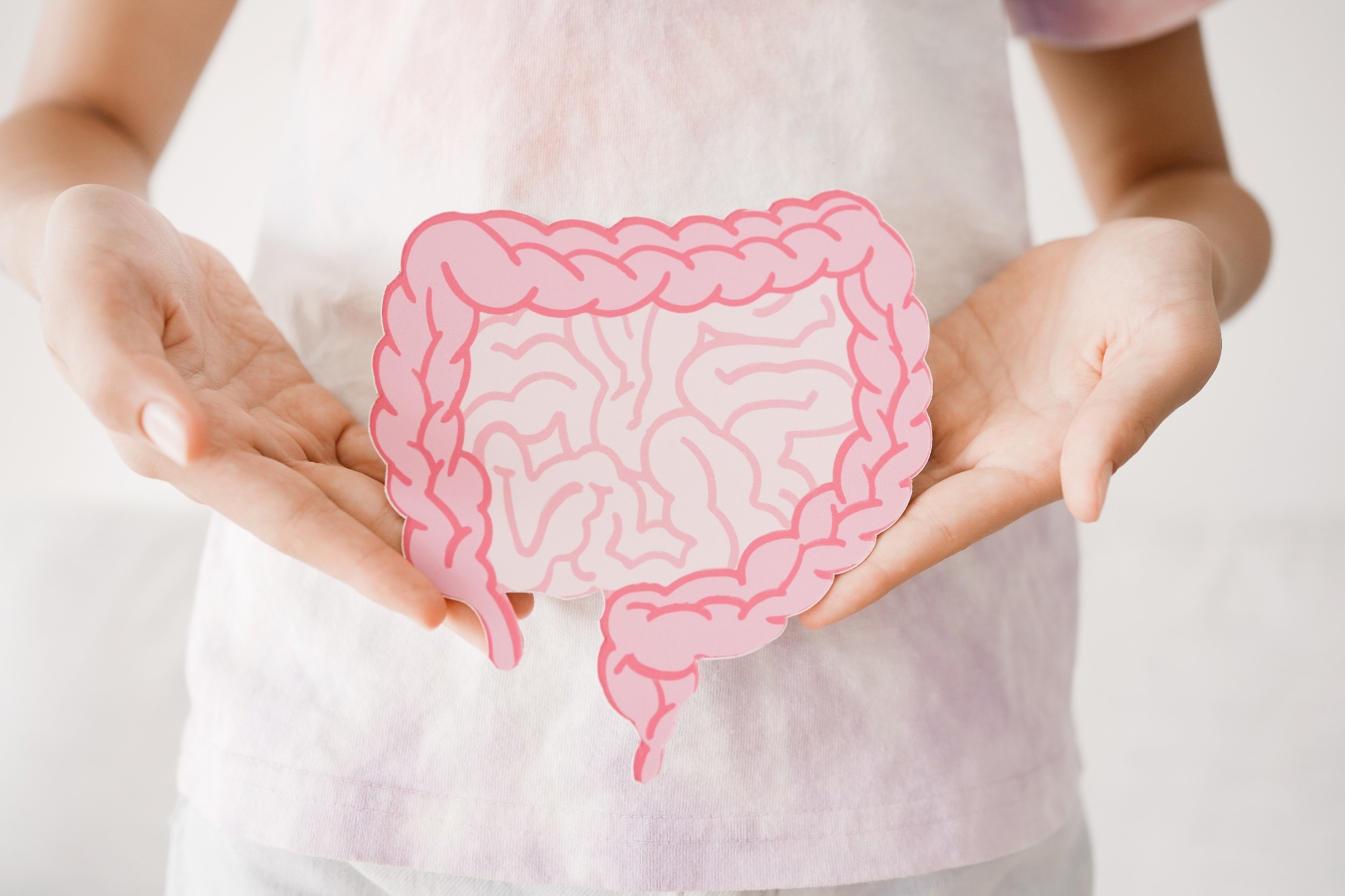 Preteen girl hands holding intestine shape.