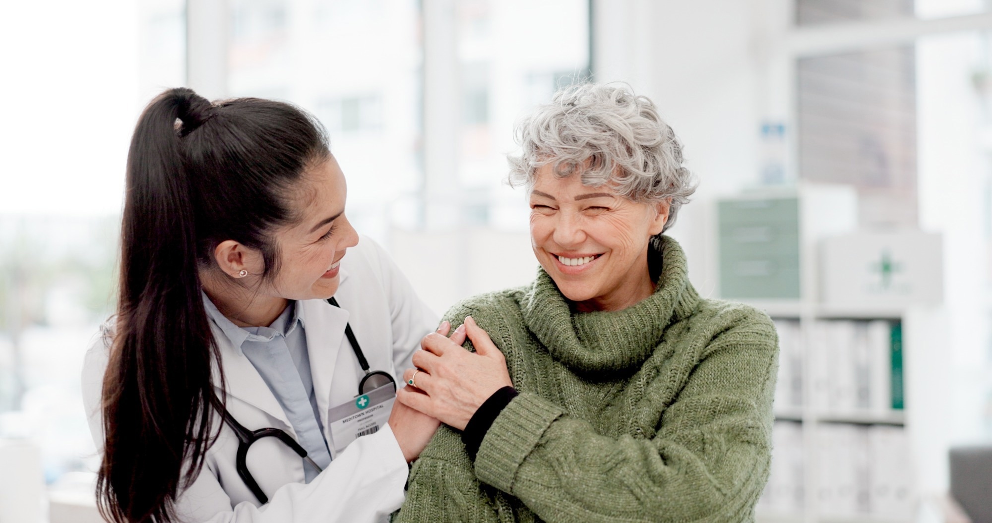 Happy, care and face of a doctor with a woman for medical trust.