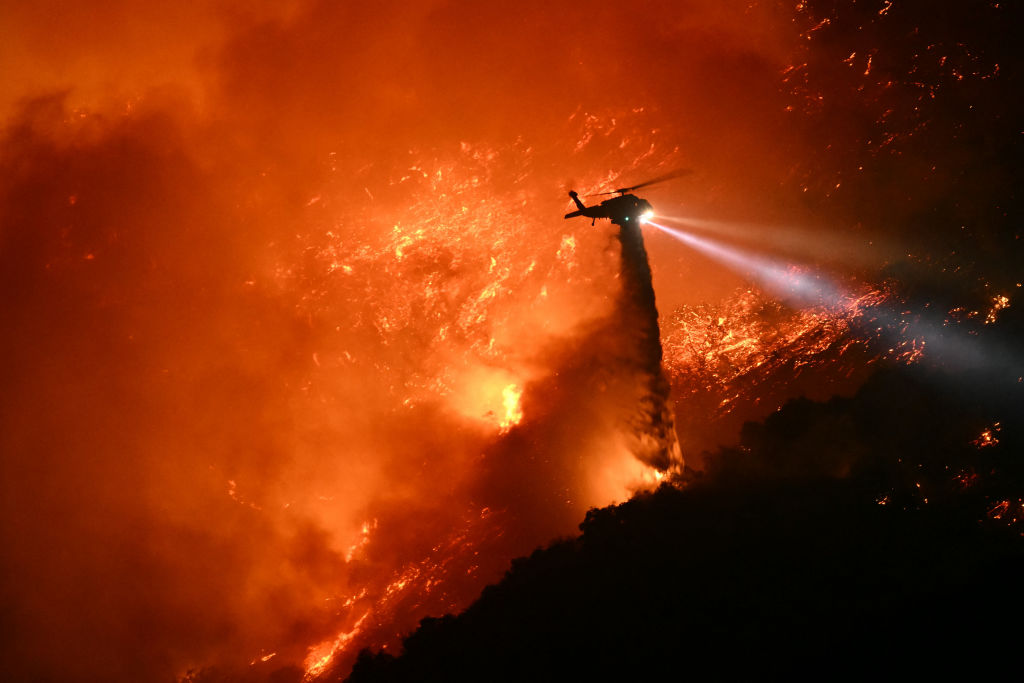 helicopter flying over LA wildfires