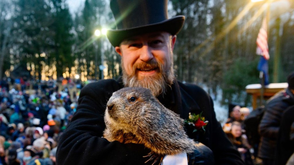 Groundhog handler AJ Derume and Punxsutawney Phil in 2022