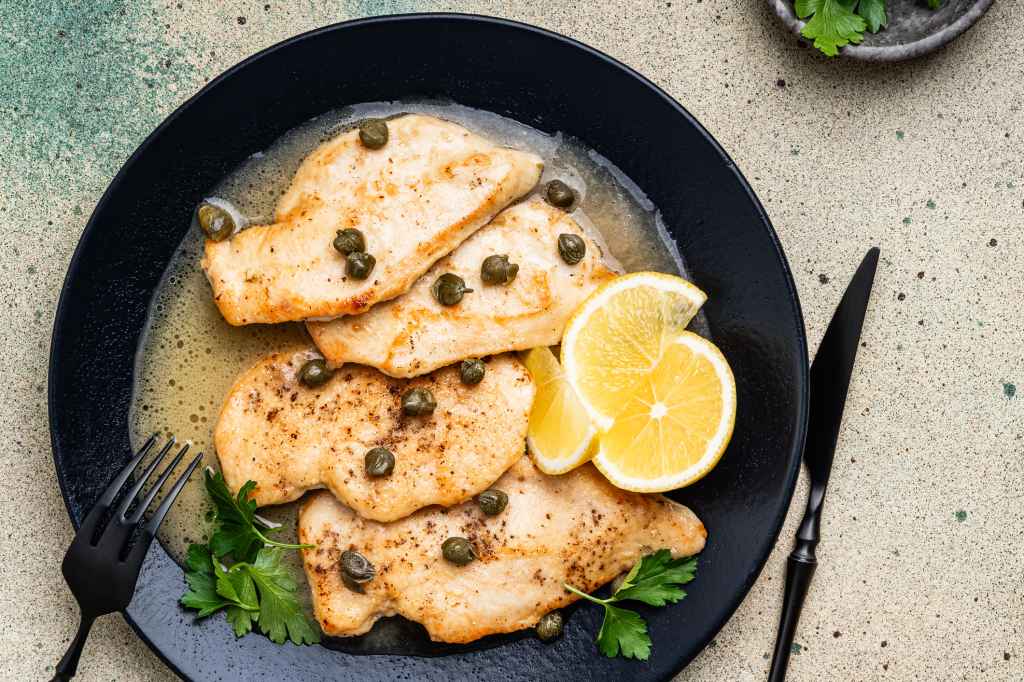 crispy chicken breasts with lemon juice, butter sauce with capers