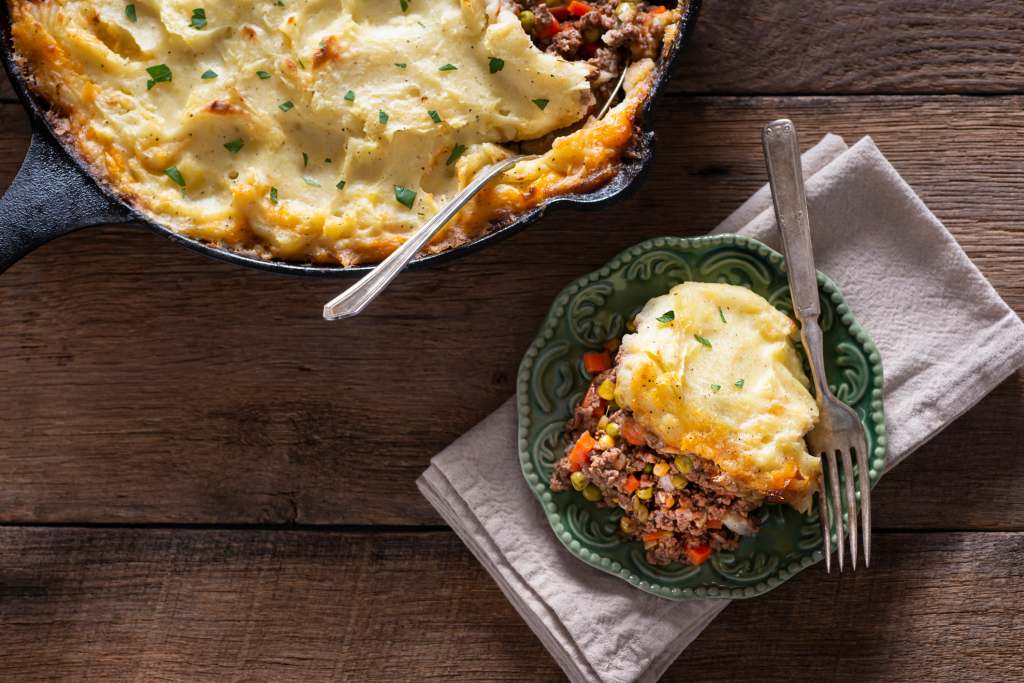 Homemade healthy shepherd's pie slice on plate with fork