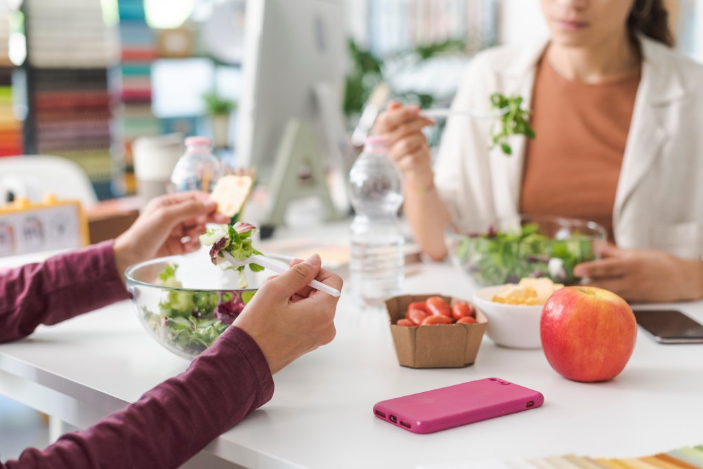 women having a lunch break together eating a Cobb salad