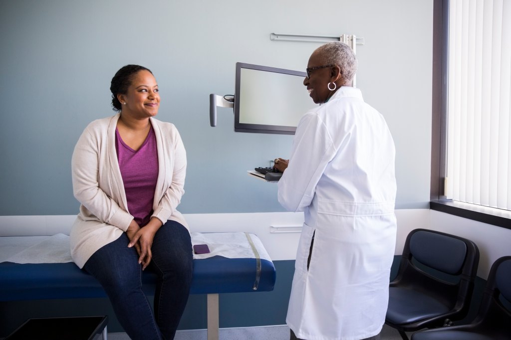 woman speaking to doctor about preventative chemotherapy in office