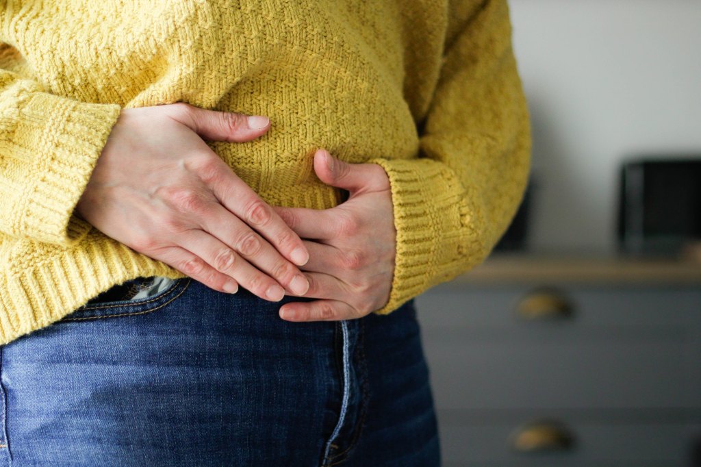 woman holding abdomen