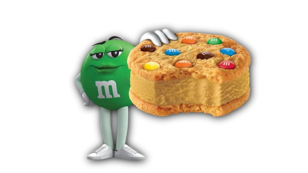 Green M&M character holding the new M&M's peanut butter ice cream cookie sandwich