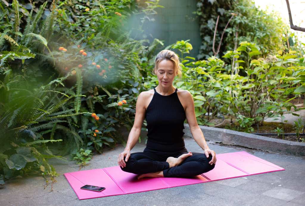 mature woman practicing meditation as a natural remedy for chronic pain