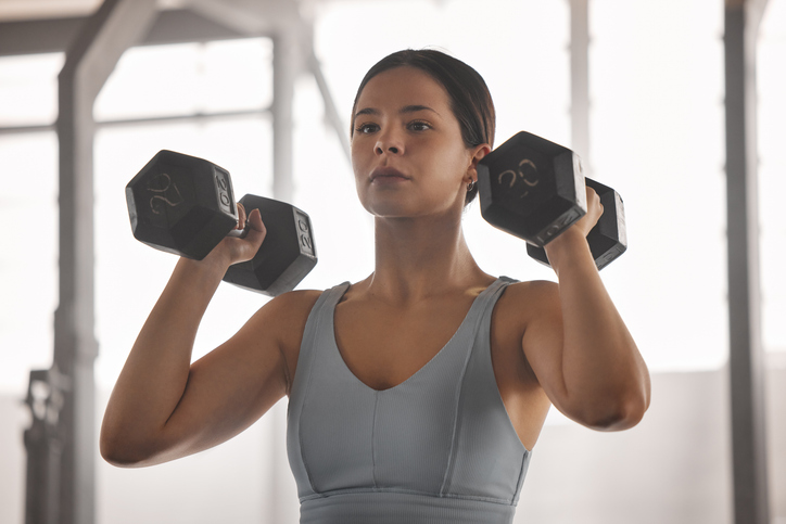 woman doing dumbbell exercise | Pea Protein