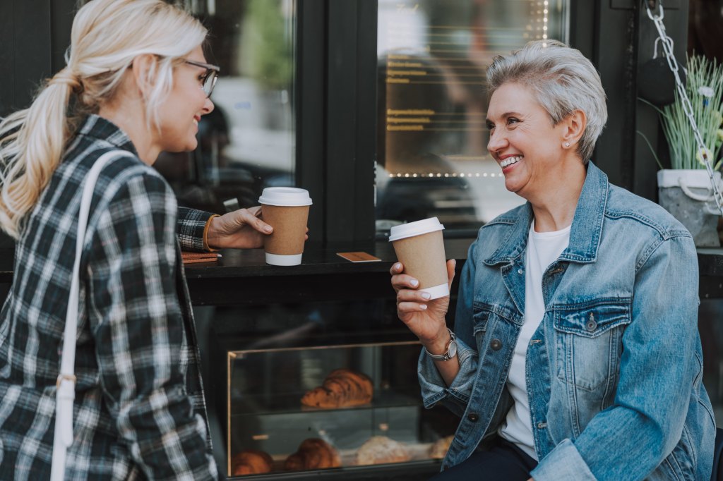 two women enjoying Starbucks coffee cups after the open-door policy reversal