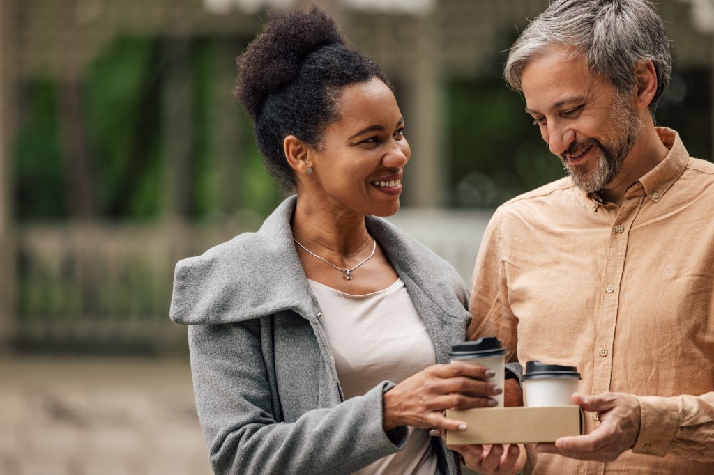 mature couple celebrating valentine's day with starbucks drinks