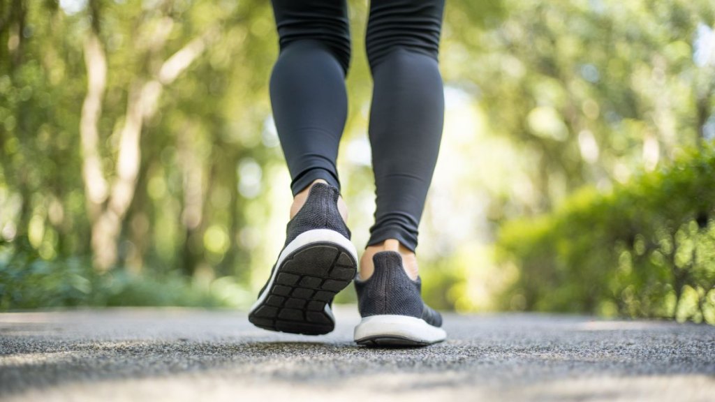 Close up of running shoes and women feet when warming up activity before running.