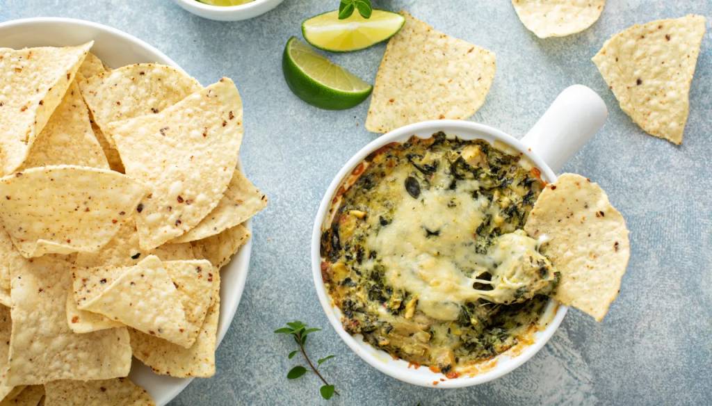 Creamy spinach artichoke dip as part of a roundup of Super Bowl snack ideas