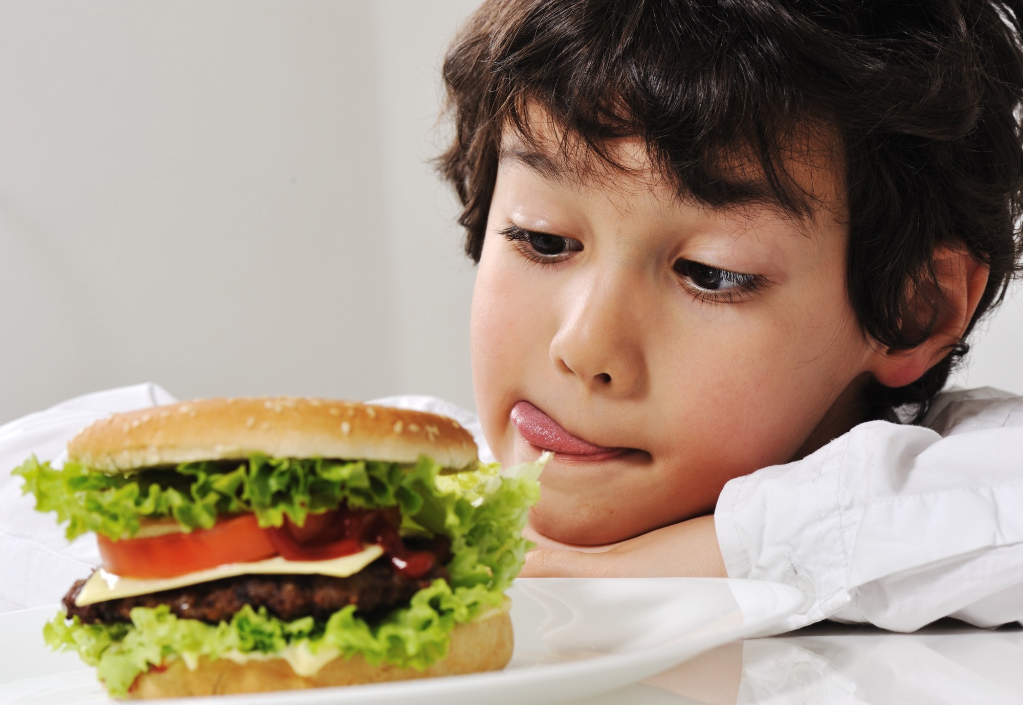 Boy on temptation with burger.