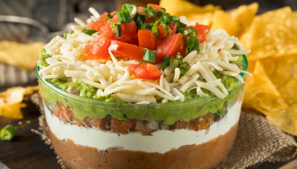 Mama Kelce’s 7-layer dip as part of a roundup of Super Bowl snack ideas