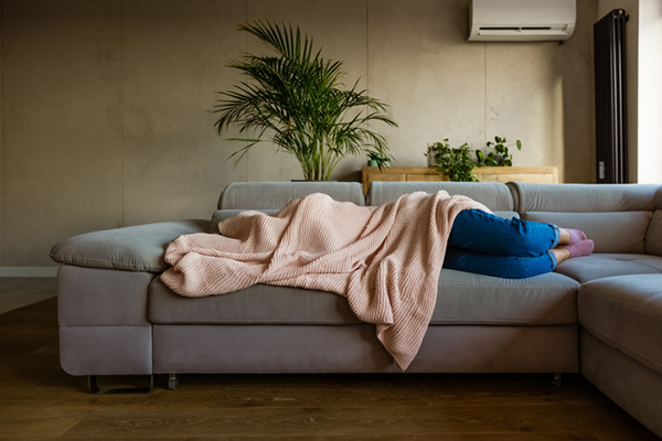 Woman Sleeps on Couch with Blanket Over Head | Hangover Recovery